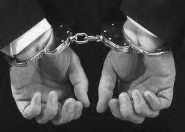 Hands in handcuffs representing arrest and the criminal defense process.